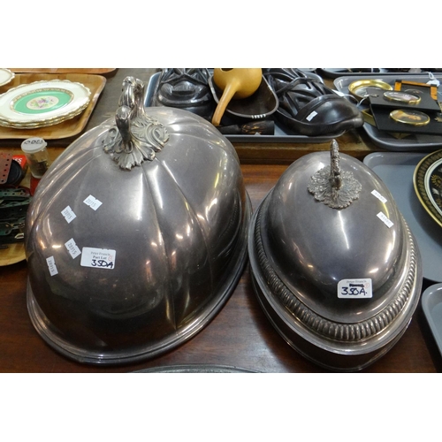 350A - Two large silver plated cloches with ornate handles and inscribed coat of arms. (2)
(B.P. 21% + VAT)