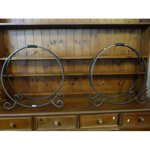 472 - Pair of wrought iron fire side log cradles of circular form with scrolled feet.  (2)  (B.P. 21% + VA... 