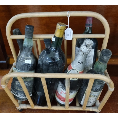 82 - Collection of alcohol in distressed condition to include: Sandeman Port, Dom Perignon Champagne 1980... 