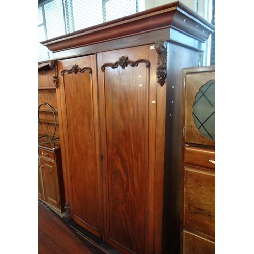 474 - Victorian mahogany two door wardrobe with hanging space and internal drawers,  on a platform base.  ... 