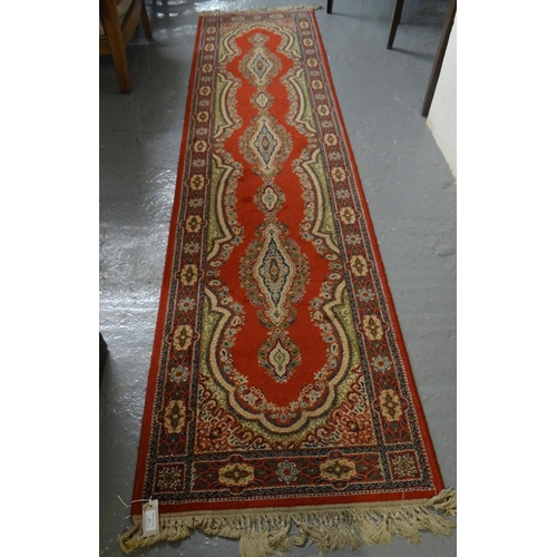 497 - Modern Persian design red ground floral and foliate runner with an arrangement of medallions to the ... 