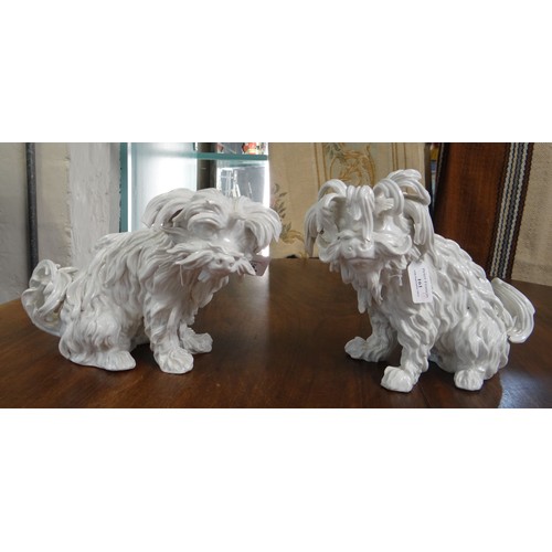 161 - Pair of continental porcelain Blanc de Chine seated fireside dogs, blue mark to the underside.  (2) ... 