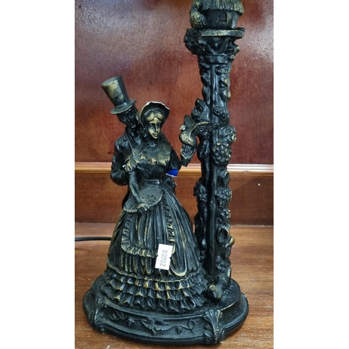 119 - Modern Tiffany style table lamp, the base with bronzed decoration of Victorian gent and lady with bi... 