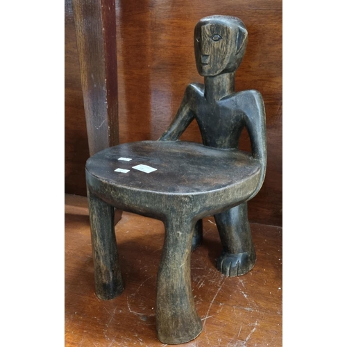 121 - African tribal hardwood child's chair with figural back rest. 
(B.P. 21% + VAT)