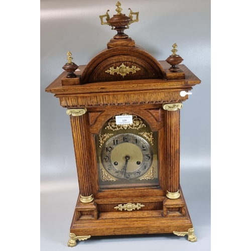 129 - Early 20th Century oak architectural two train mantel clock with urn finial, gilded and gold finish ... 