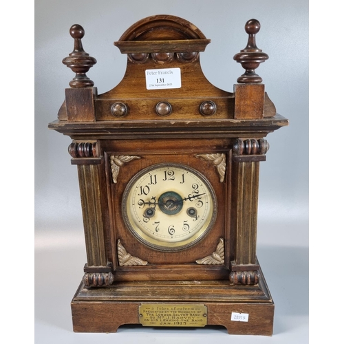 131 - Early 20th century walnut two train architectural presentation mantle clock with a plaque dated 1913... 