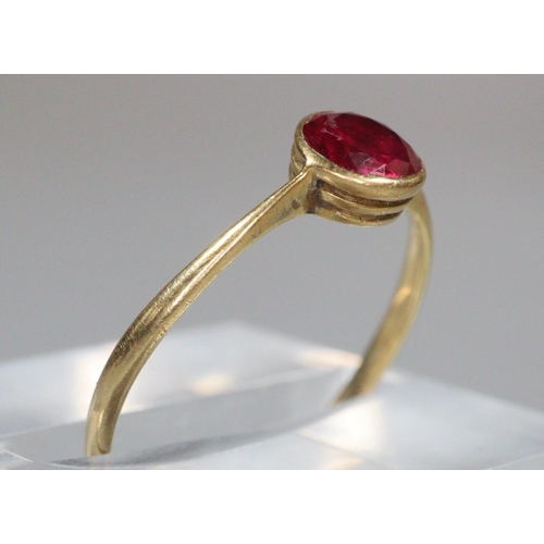 196 - 18ct gold and red stone dress ring. 1.1g approx. Ring size N.
(B.P. 21% + VAT)