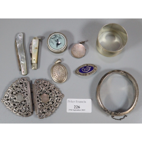 226 - Bag of items to include: silver engine turned napkin ring, silver bangle, two mother of pearl and si... 