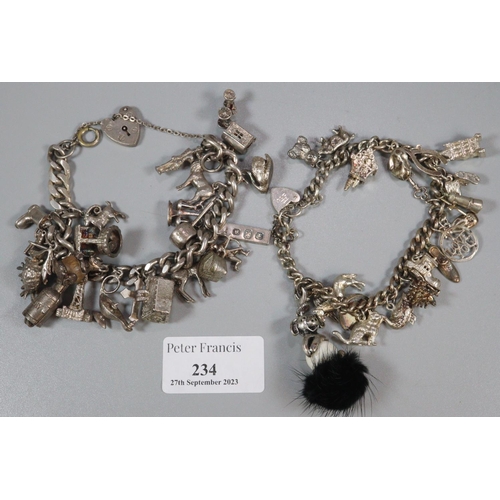 234 - Two silver charm bracelets with a large collection of assorted charms; animals, chair, wishbone, bui... 