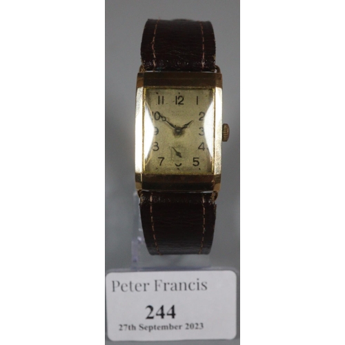 244 - 9ct gold rectangular gent's wristwatch with leather strap, the face indistinctly marked.
(B.P. 21% +... 