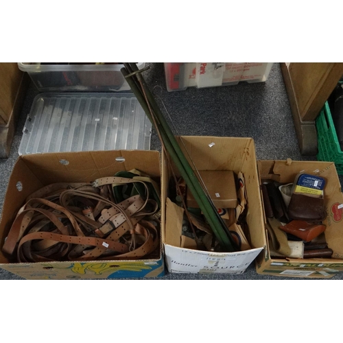 319 - Three boxes of shooting and rifle accessories to include; cleaning rods, leather belts, gun sight, t... 