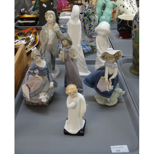 331 - Tray of seven figurines to include: Spanish porcelain Lladro and Nao, Royal Doulton 'Darling' HN1985... 