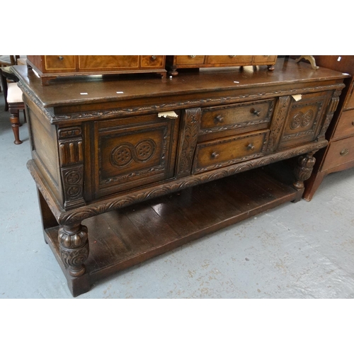 397 - 17th Century style carved oak sideboard with an arrangement of two central drawers, standing on balu... 