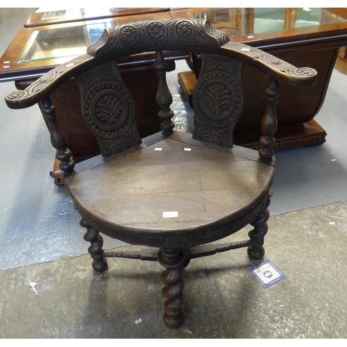 464 - 18th Century style carved oak corner chair, standing on barley twist legs and X stretcher frame.
(B.... 