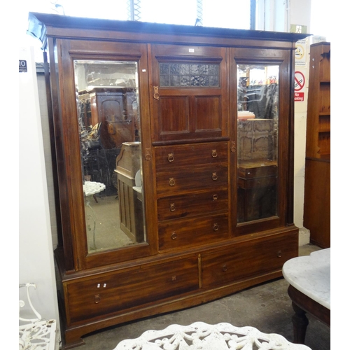 473 - Liberty style, an early 20th Century mahogany two door glazed wardrobe with copper finish handles.
(... 