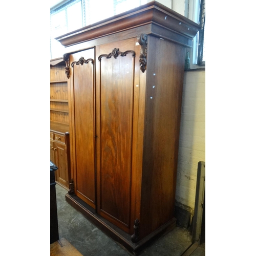 476 - Victorian mahogany two door wardrobe with hanging space and internal drawers,  on a platform base.  ... 