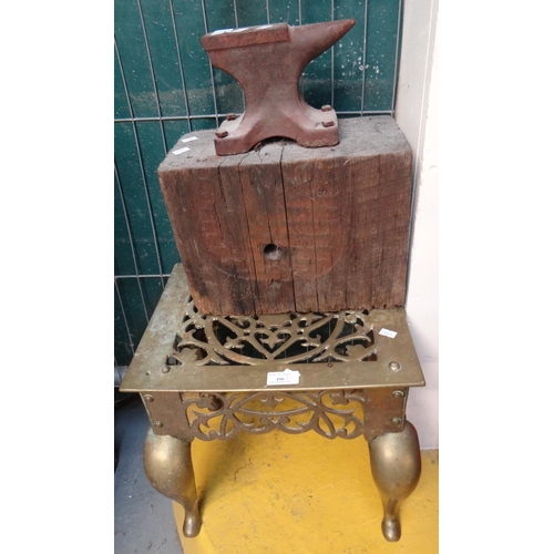 490 - Victorian traditional brass pierced footman, together with a small cast iron anvil on wooden block.
... 