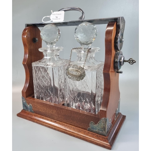 74 - Victorian style mahogany and chrome tantalus comprising two crystal square section decanters with fa... 