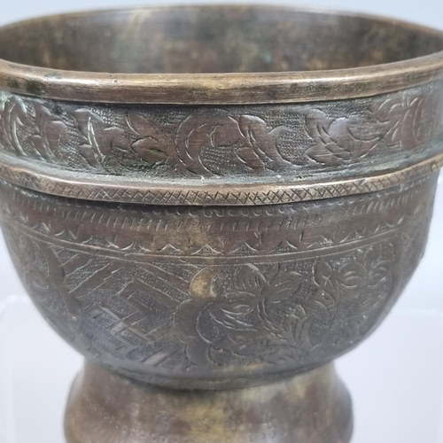 86 - Probably Indonesian brass Bokor bowl engraved with flowers and foliage. 10cm high, 11cm diameter app... 