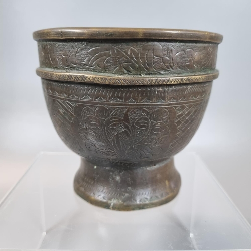 86 - Probably Indonesian brass Bokor bowl engraved with flowers and foliage. 10cm high, 11cm diameter app... 