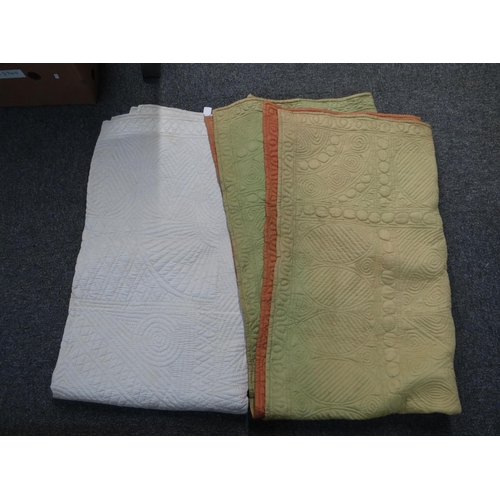 406 - Two vintage Welsh quilts; one cream and the other pale green with orange reverse, both with sewn in ... 