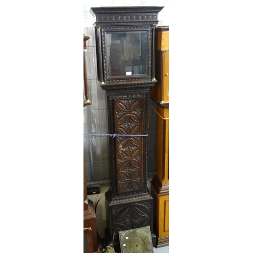 476 - Carved oak long case clock with brass face and later 19th century movement, the face marked 'John An... 