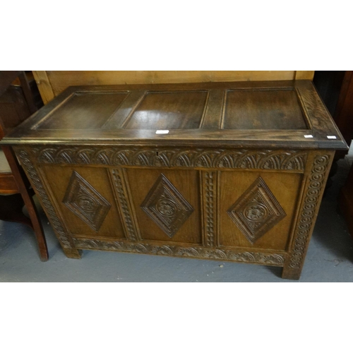 503 - 18th Century style oak coffer, the hinged lid above three carved lozenge panels with flower heads, s... 