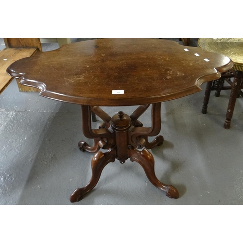 552 - Victorian style mahogany table, the shaped oval top above a carved ornate quatrefoil base.  (B.P. 21... 