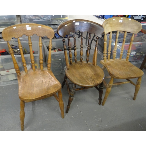 556 - Three similar beech and elm spindle backed kitchen chairs.  (3)   (B.P. 21% + VAT)