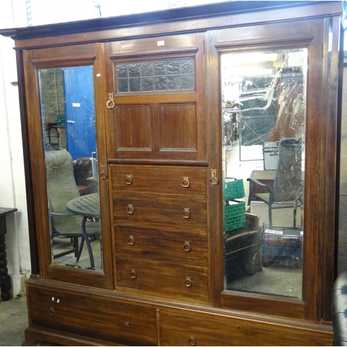 561 - Liberty style, an early 20th Century mahogany two door glazed wardrobe with copper finish handles.
(... 