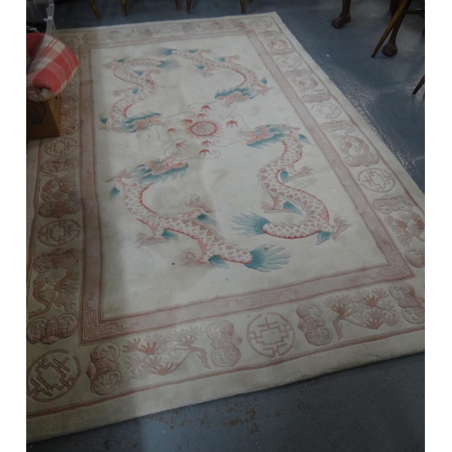 581 - Cream ground Chinese wash rug decorated with dragons chasing a flaming pearl.  253x154cm approx.   (... 