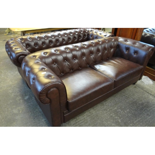 585 - Two similar modern brown leather Chesterfield style large two seater sofas with shaped arms on balus... 