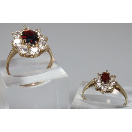 245 - Two 9ct gold flowerhead dress rings.  4.5g approx.  Size L and M. (2)  (B.P. 21% + VAT)