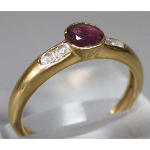 253 - Yellow metal red and clear stone dress ring in associate box.  3g approx.  Size P.  (B.P. 21% + VAT)