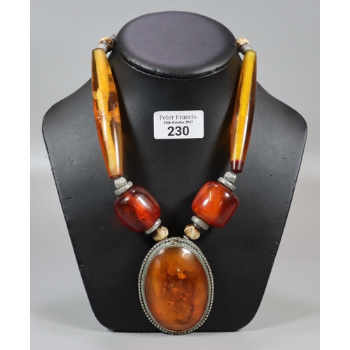 230 - Large amber coloured necklace with carved beadwork.   (B.P. 21% + VAT)