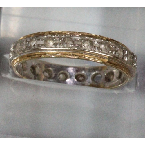 239 - 18ct gold eternity ring.  3.1g approx.  Missing one stone (not diamonds).   (B.P. 21% + VAT)