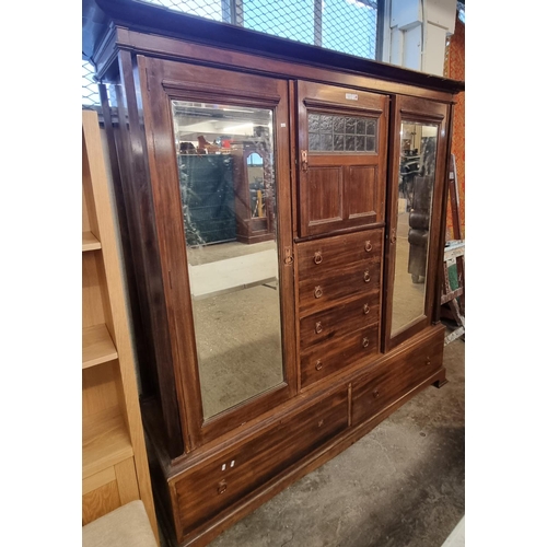 512 - Liberty style, an early 20th Century mahogany two door glazed wardrobe with copper finish handles.
(... 