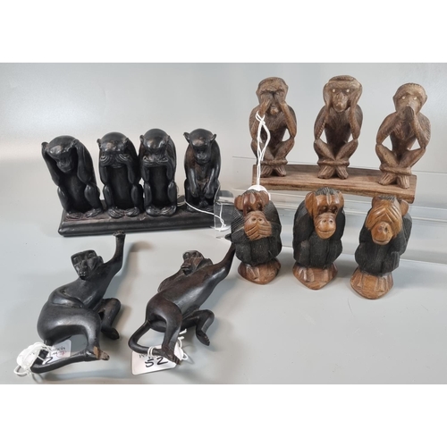 52 - A mixed group of carved wooden monkey figures in various poses; three wise monkeys (see no evil, hea... 