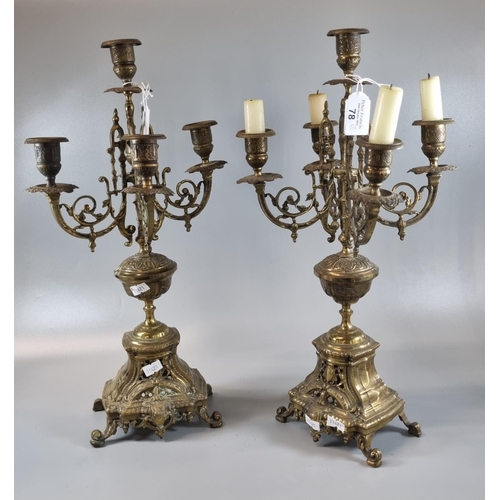 78 - Pair of ornate brass rococo style four branch table candelabrum.  (2)  (B.P. 21% + VAT)