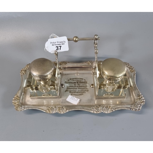 37 - Silver plated presentation ink stand with two glass inkwells, having presentation inscription 'Llane... 