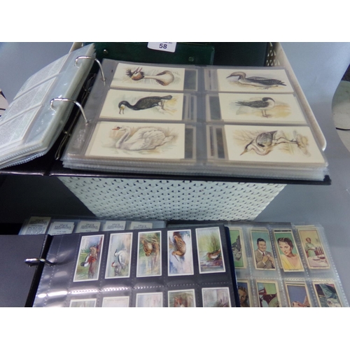 58 - Cigarette cards and various trade cards in five albums, many 100s of cards with a wide range of subj... 