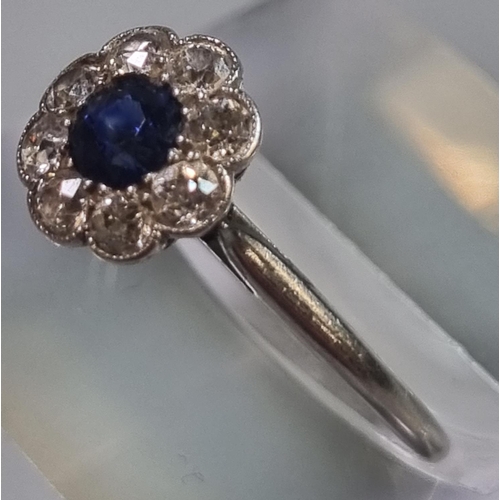 199 - Platinum eight stone diamond daisy ring with central sapphire stone.  2.2g approx.  Size K1/2.   (B.... 