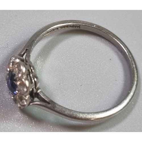 199 - Platinum eight stone diamond daisy ring with central sapphire stone.  2.2g approx.  Size K1/2.   (B.... 