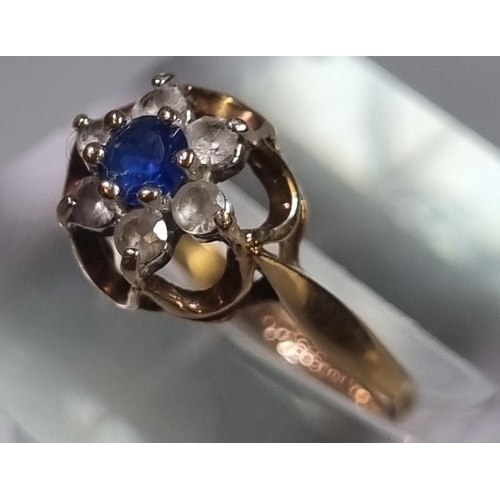 224 - 9ct gold clear and blue stone flowerhead dress ring.  1.6g approx.  Size J1/2.  (B.P. 21% + VAT)