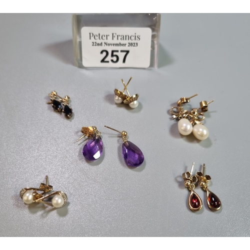 257 - Collection of yellow metal pierced ear drop earrings set with pearls and coloured stones, some marke... 