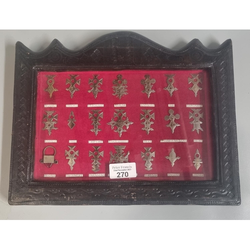 270 - Collection of silver Touareg Niger crosses in ornate leather frame.  33x26cm approx.   (B.P. 21% + V... 