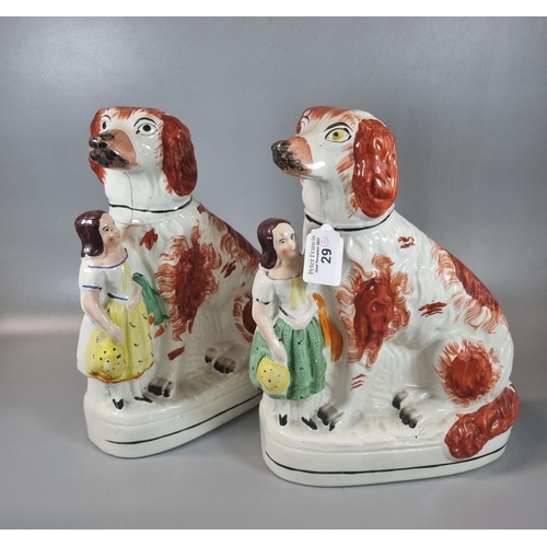 29 - Two 19th century Staffordshire Pottery seated red and white Spaniels, each with a standing young gir... 
