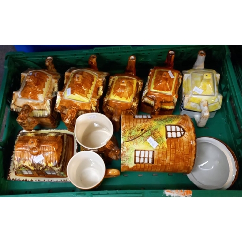 398 - Four boxes/crates of novelty teapots in the form of cottages etc.  (4)  (B.P. 21% + VAT)