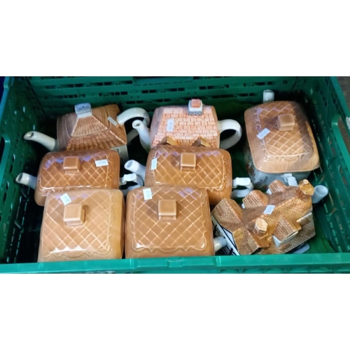 398 - Four boxes/crates of novelty teapots in the form of cottages etc.  (4)  (B.P. 21% + VAT)