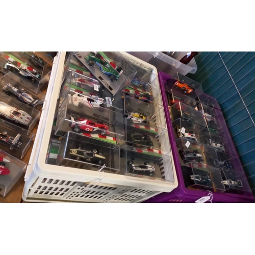 433 - Large collection of small scale Formula 1 cars from the 1950s to the present day, all in Perspex dis...